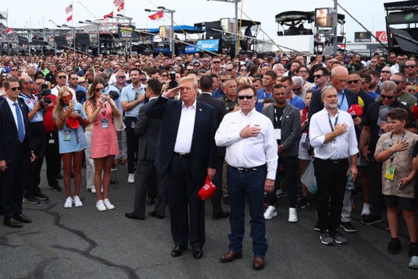 Former U.S. President and Republican presidential candidate Donald Trump stands on the grid with NASCAR team owner Richard Childress prior to the...