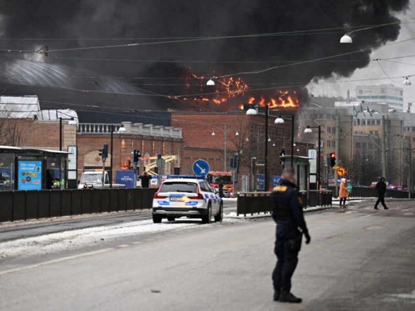 Smoke and flames rise from a building after a fire broke out at the Oceana Waterworld at t