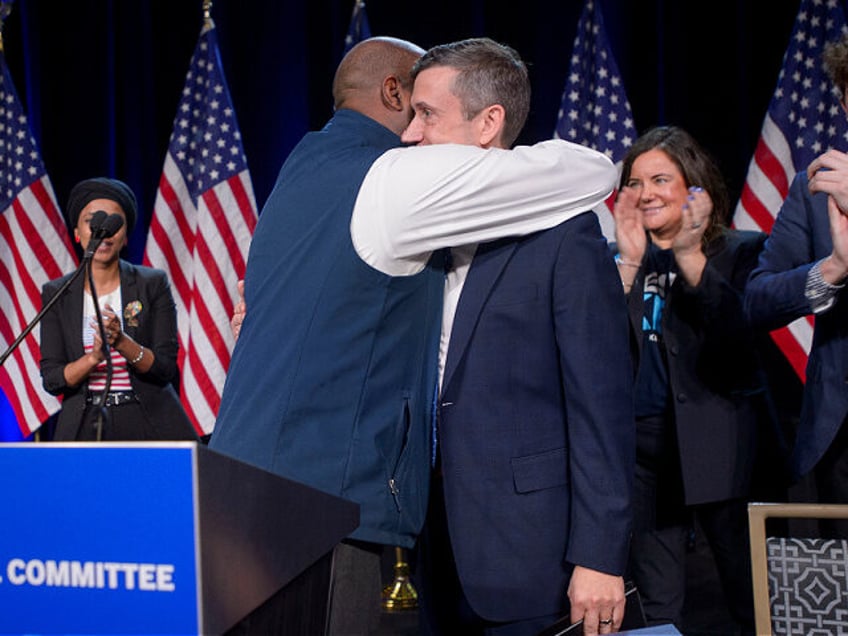 Former Democratic National Committe Chairman Jamie Harrison, left, congratulates newly ele