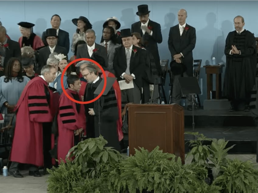 Harvard Chabad Rabbi Hirschy Zarchi, right (encircled), confronts Nobel laureate Maria Res