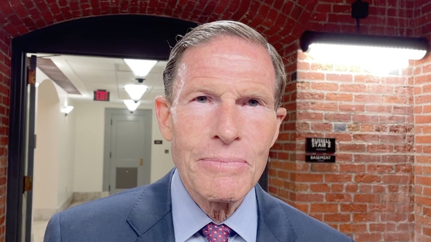 Sen. Richard Blumenthal interviewing in a senate basement hallway