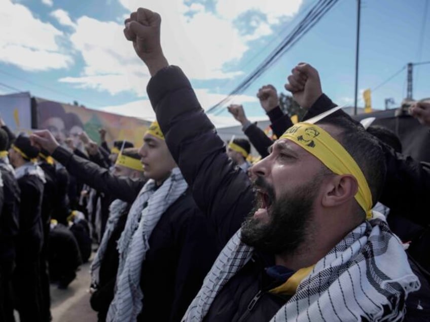 Hezbollah supporters chant slogans during the funeral procession of Lebanon's former