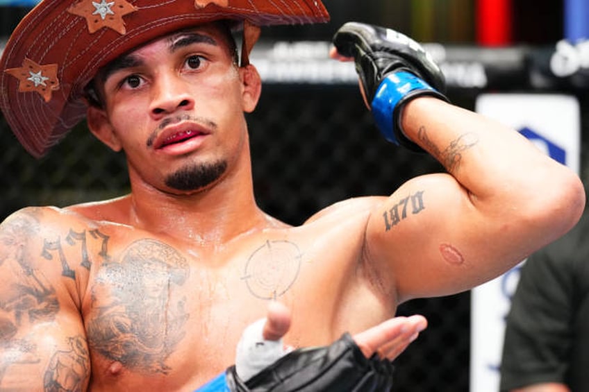 Andre Lima of Brazil shows a bite mark on his arm after his flyweight fight against Igor Severino of Brazil during the UFC Fight Night event at UFC...