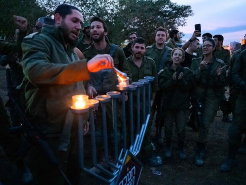 watch israeli troops light hanukkah candles in palestine square gaza