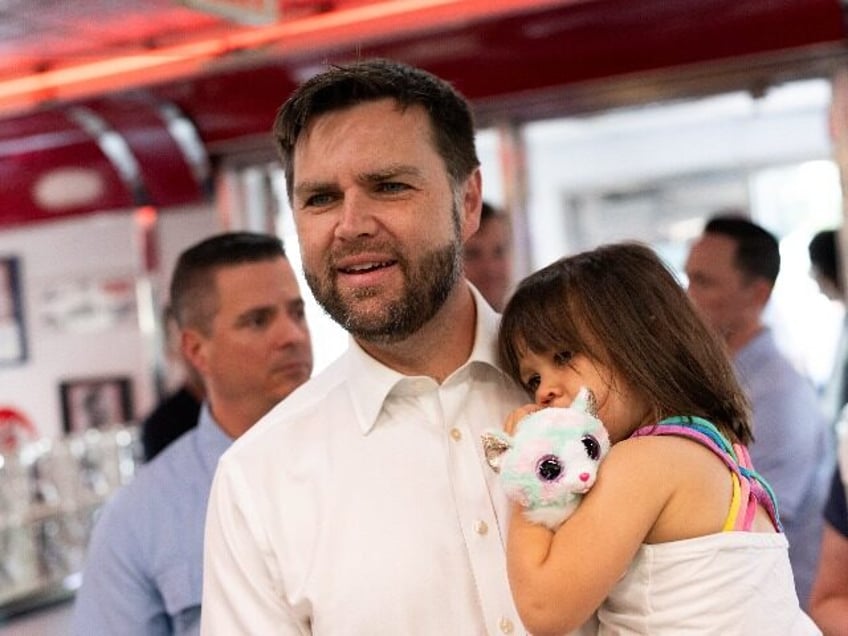 Republican vice presidential nominee U.S. Sen. J.D. Vance (R-OH) carries his daughter Mari