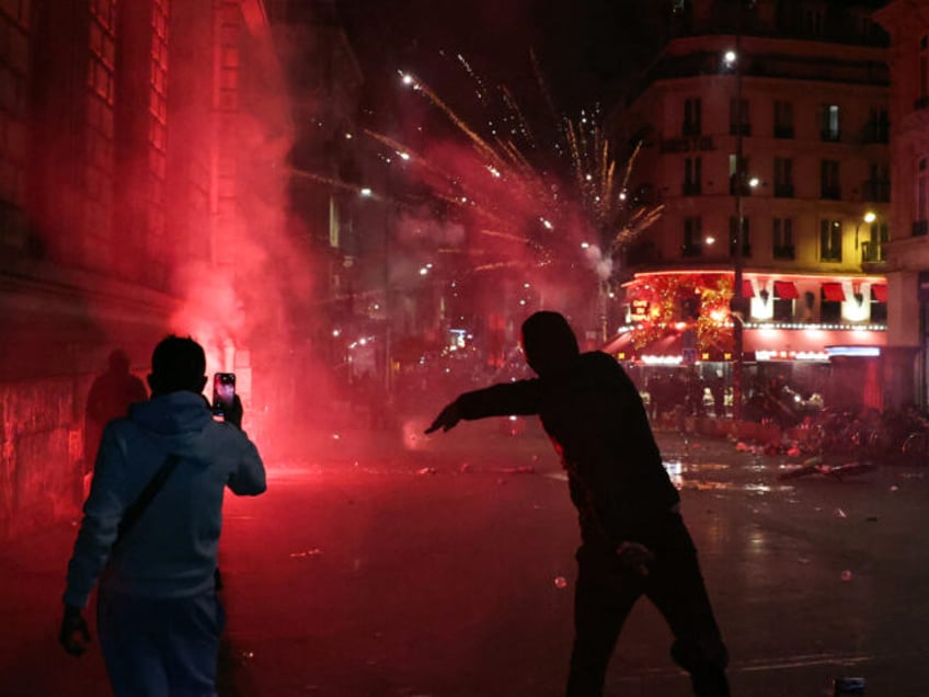 Demonstrators gesture as clashes occure on the outskirts of a gathering for the election n