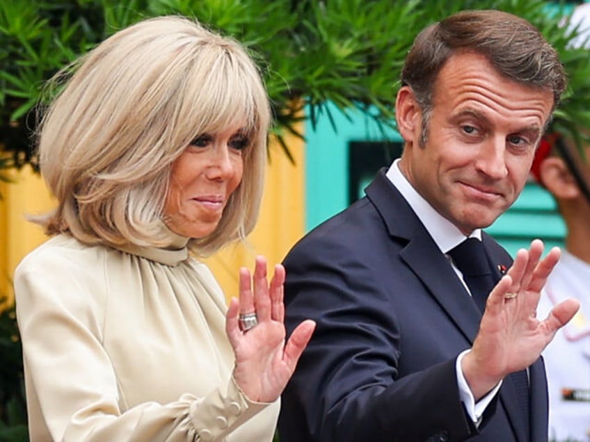 France's President Emmanuel Macron and his wife Brigitte Macron wave at the Presidential P