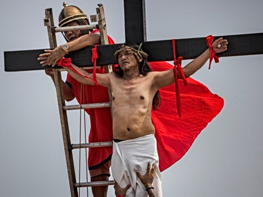 SAN FERNANDO, PHILIPPINES - APRIL 07: Penitent Ruben Enaje is removed from a cross after h