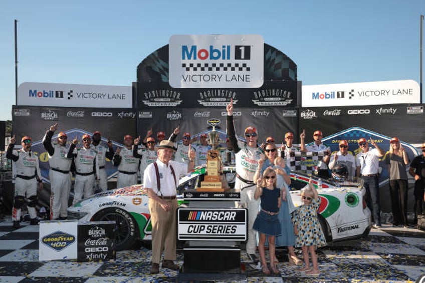 Brad Keselowski, driver of the Castrol Ford, celebrates with RFK Racing founder, Jack Roush, wife, Paige Keselowski and daughters, Autumn Keselowski...