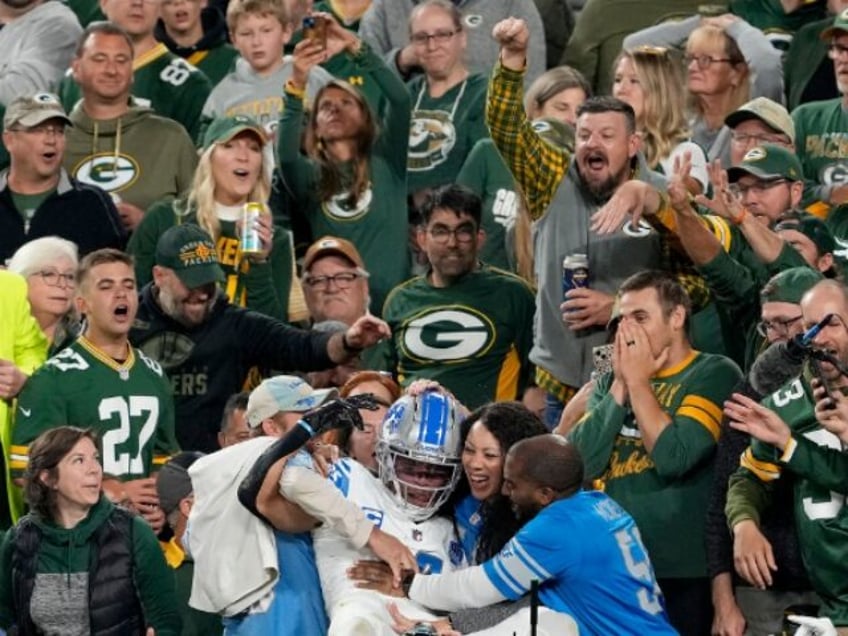 watch packers fan dumps beer on lions receiver after td