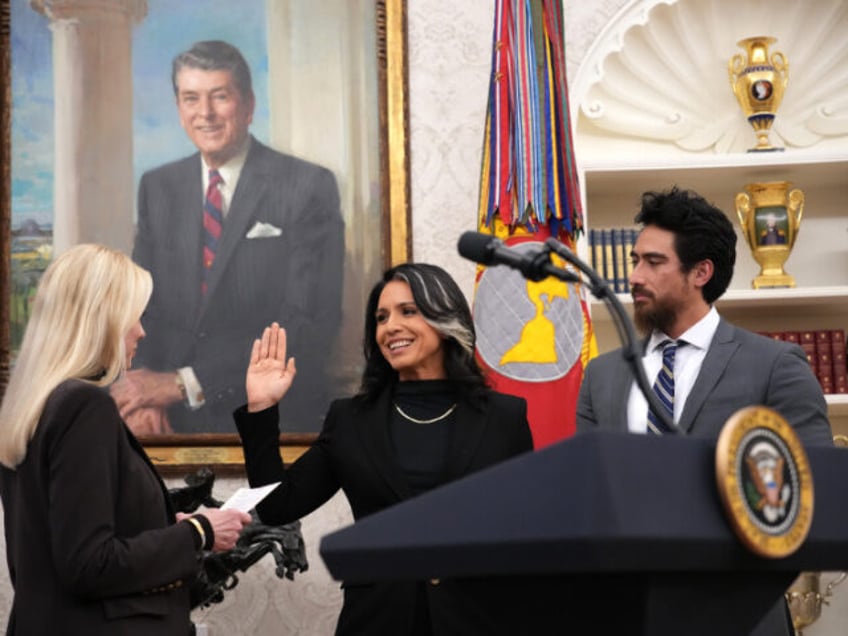 Tulsi Gabbard, joined by her husband Abraham Williams, is sworn in as director of national