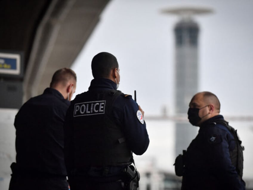 Police officers stand guard at the Paris-Charles-de-Gaulle airport in Roissy, outside Pari