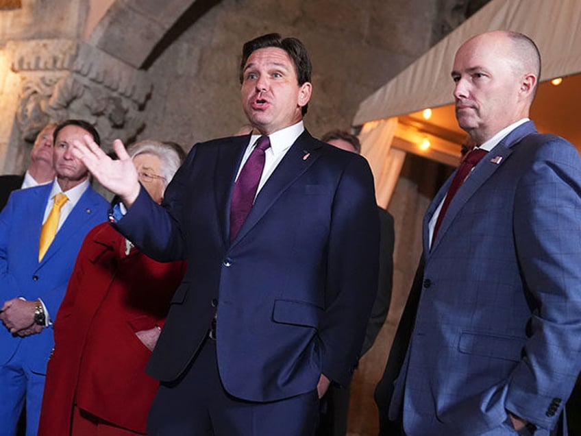 Florida Gov. Ron DeSantis speaks as Utah Gov. Spencer Cox listens before President-elect D