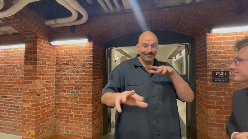 watch sen john fetterman gives odd animated reaction to news of biden impeachment inquiry