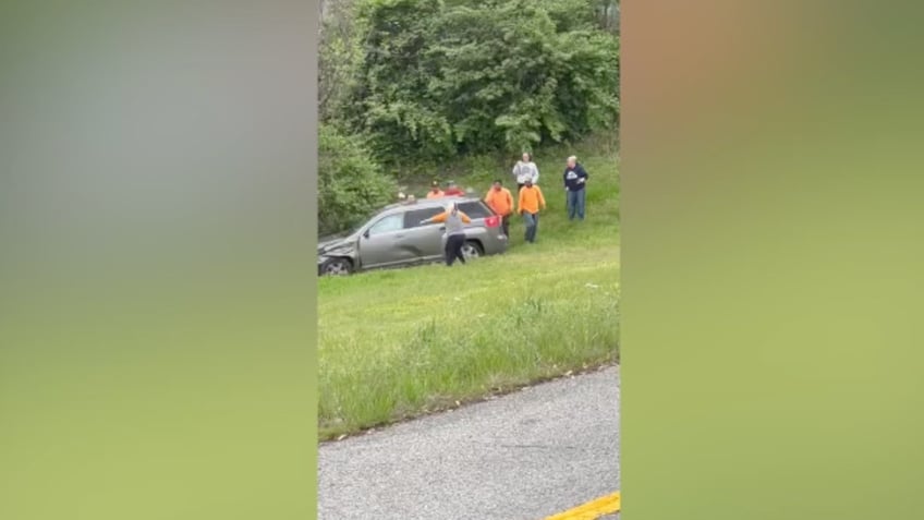 Video of people helping woman trapped in car