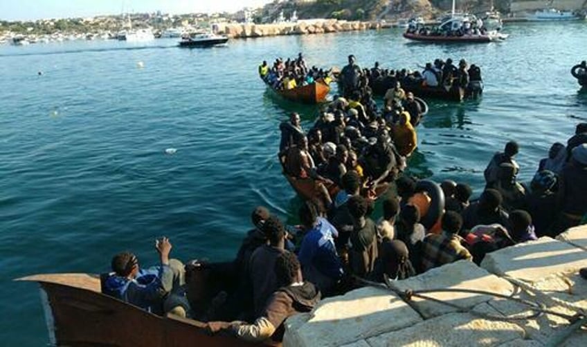 watch tiny italian island overwhelmed by 7000 migrants arriving in small boats within 24 hours