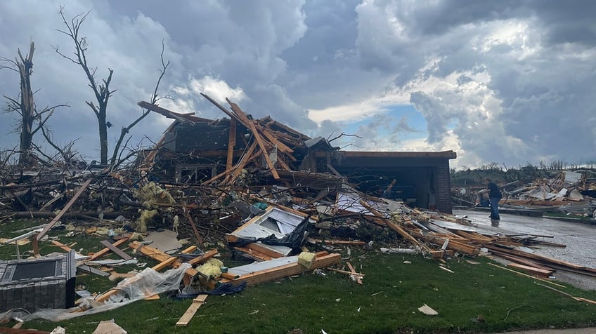 Home covered in tornado debris