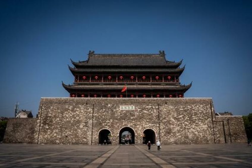 watch tourists scramble as ancient chinese tower partially collapses 