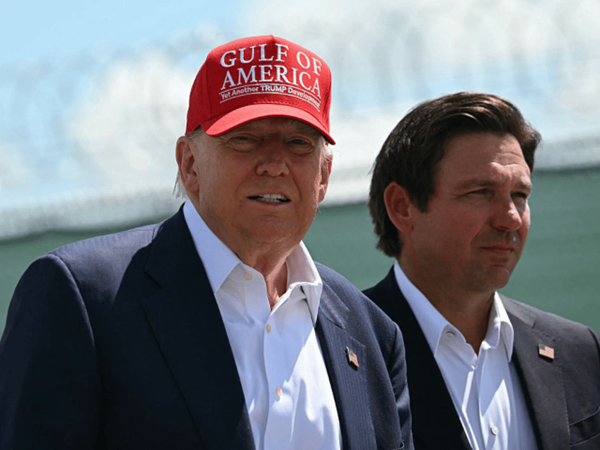 US President President Donald Trump and Florida Governor Ron DeSantis tour a migrant deten