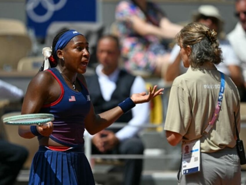 US' Coco Gauff speaks with an official after a call goes against her while playing Cr