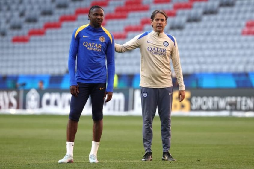 Inter coach Simone Inzaghi (R) with striker Marcus Thuram during a team training session o