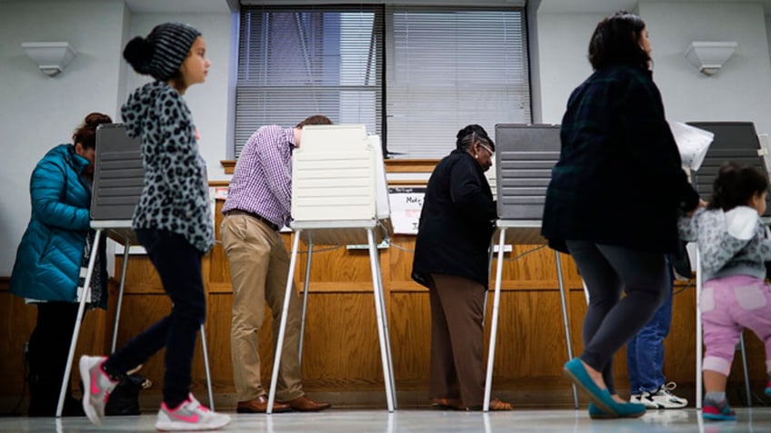 Voters fill out their ballots at the Nativity School polling place on Election Day, Tuesday, Nov. 8, 2016, in Cincinnati. (AP Photo/John Minchillo)