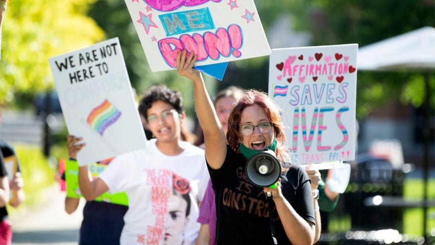 A student leads a group of demonstrators in Knoxville, Tennessee, in protest of the state’s 2022 transgender athlete ban. (Saul Young/Knoxville News-Sentinel /USA Today)