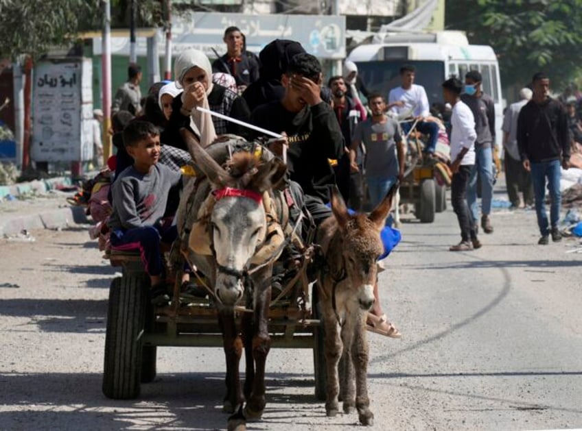 weary families trudge through gaza streets trying to flee the north before israels invasion