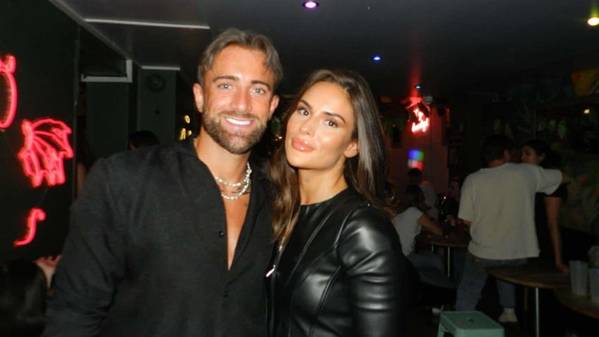 Man and woman in nightclub looking at camera