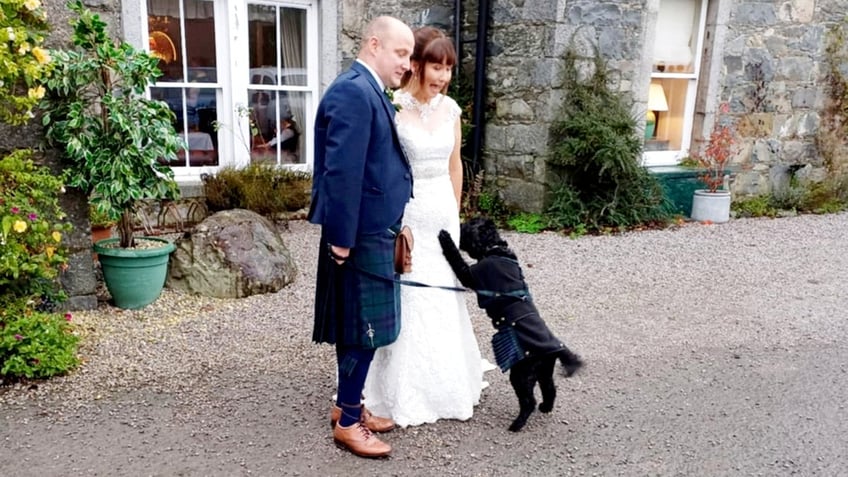 Wayne and Sarah Marshall were accompanied on their wedding day by Archie, the couple's cockapoo.