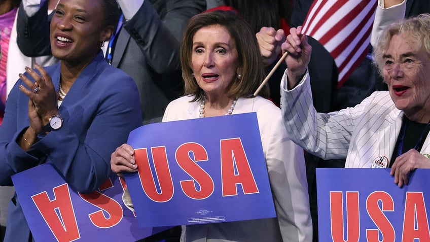 U.S. Representative Nancy Pelosi (D-CA) holds a USA sign during Day 4 of the Democratic National Convention