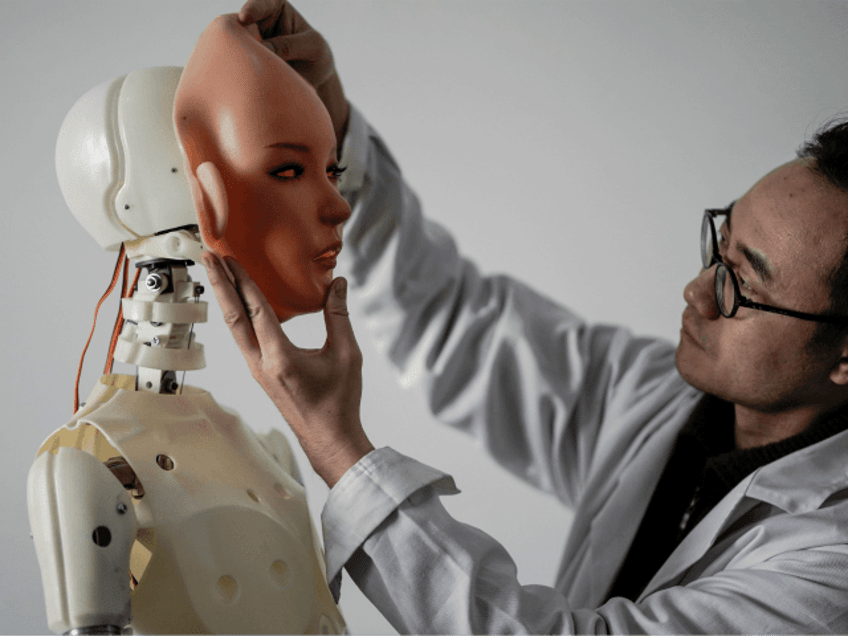 TOPSHOT - This photo taken on February 1, 2018 shows an engineer holding a silicon face ag