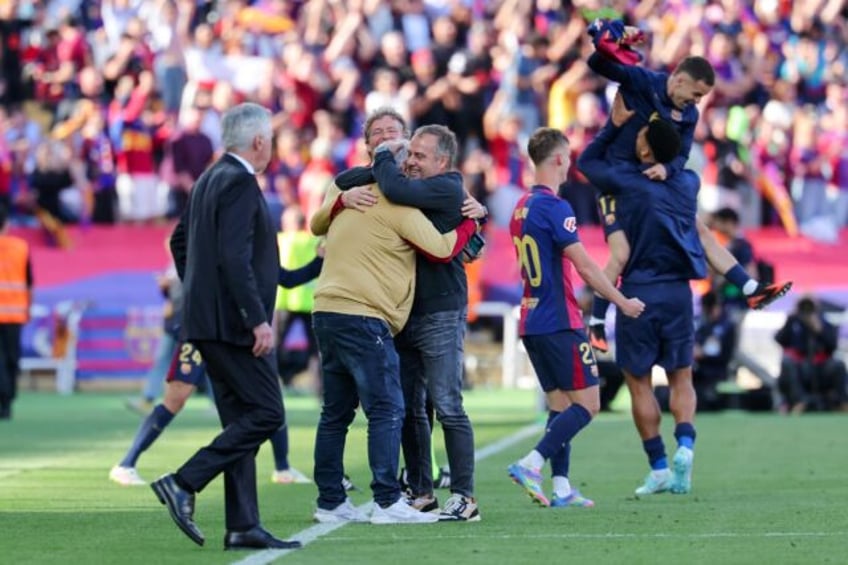 Barcelona coach Hansi Flick celebrates with his staff after winning the Clasico on Sunday
