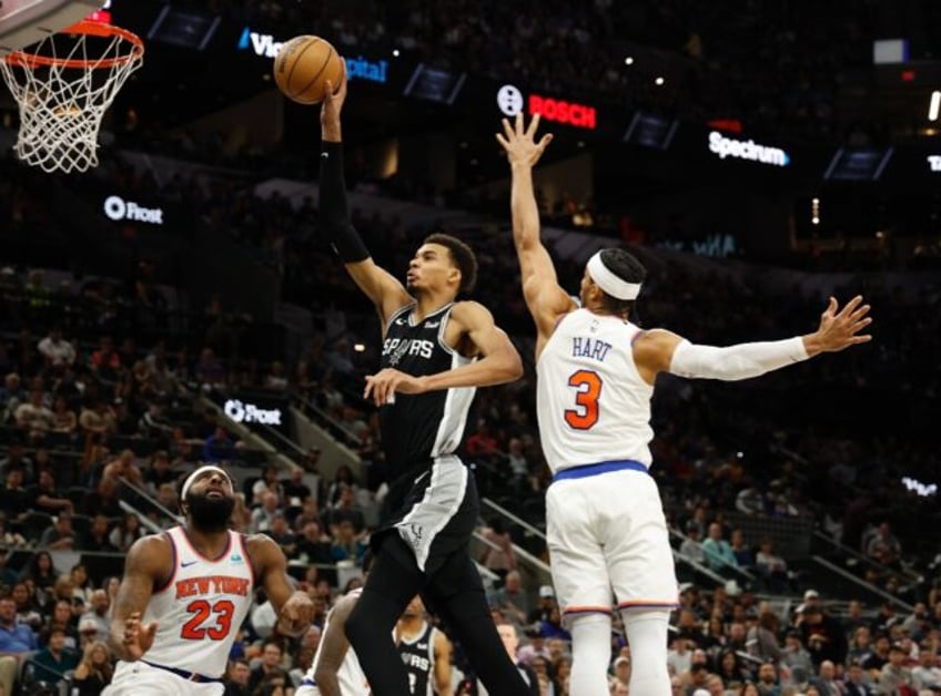 San Antonio rookie Victor Wembanyama drives past New York's Josh Hart in the Spurs NBA ove