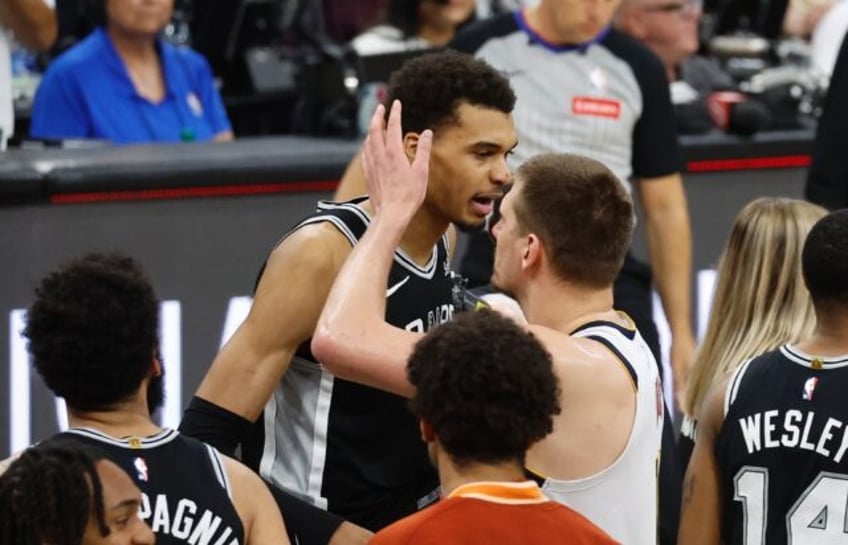 San Antonio Spurs rookie Victor Wembanyama is congratulated by Denver's Nikola Jokic after