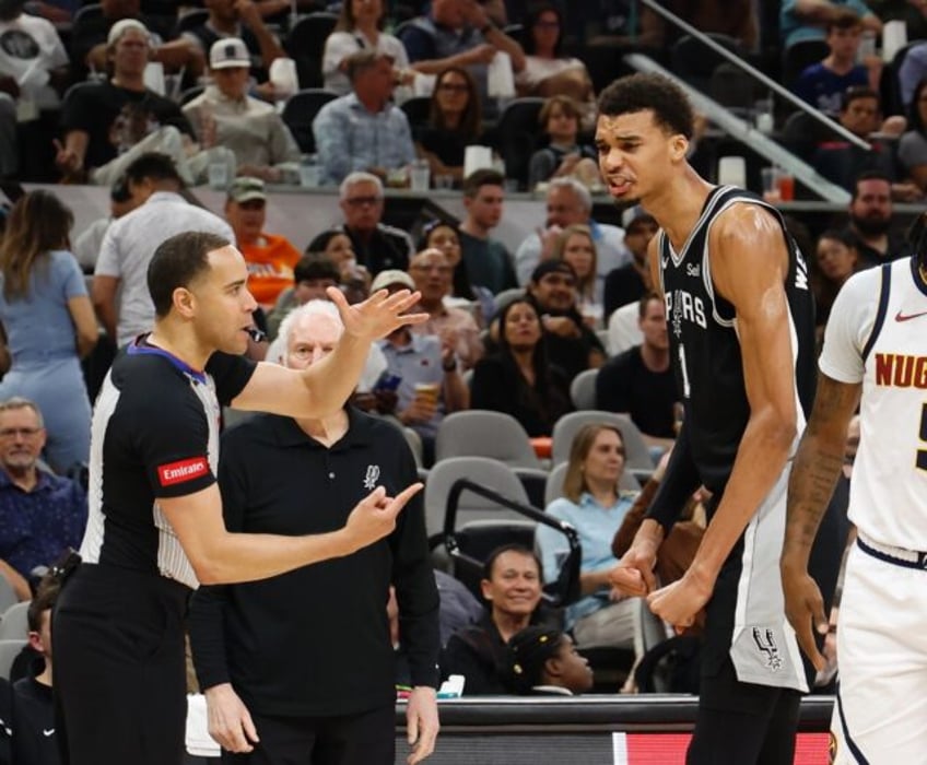 Victor Wembanyama remonstrates with an official during San Antonio's upset of Denver on Fr