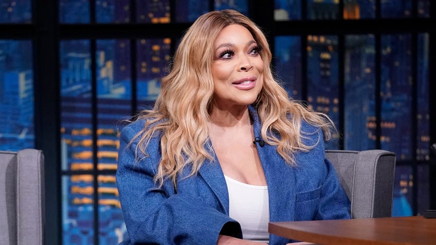 Wendy Williams blue denim blazer with Seth Meyers