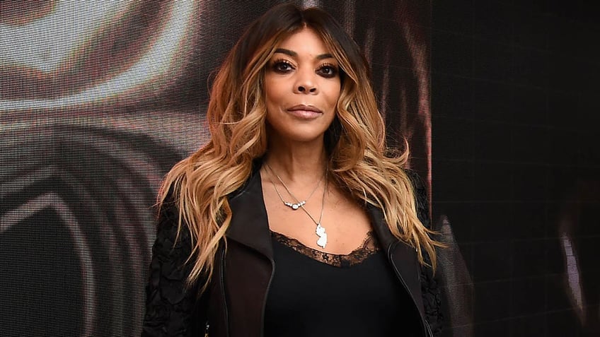 Wendy Williams in a black lace tanktop and brown suede jacket 