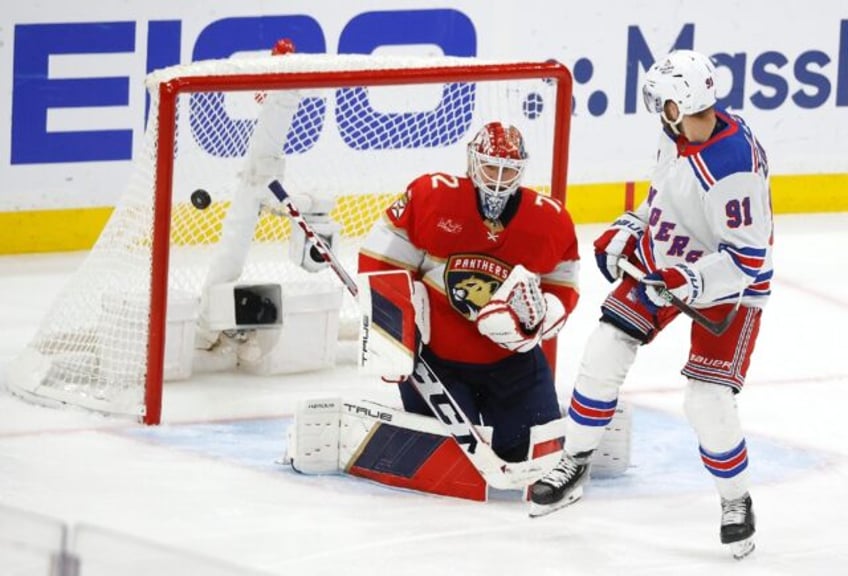 Alex Wennberg of the New York Rangers scores the game winning goal in overtime against the