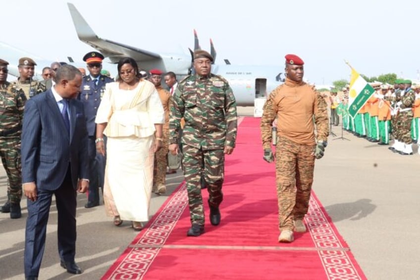 Niger's General Abdourahamane Tiani (C), pictured with his Burkinabe counterpart Captain I