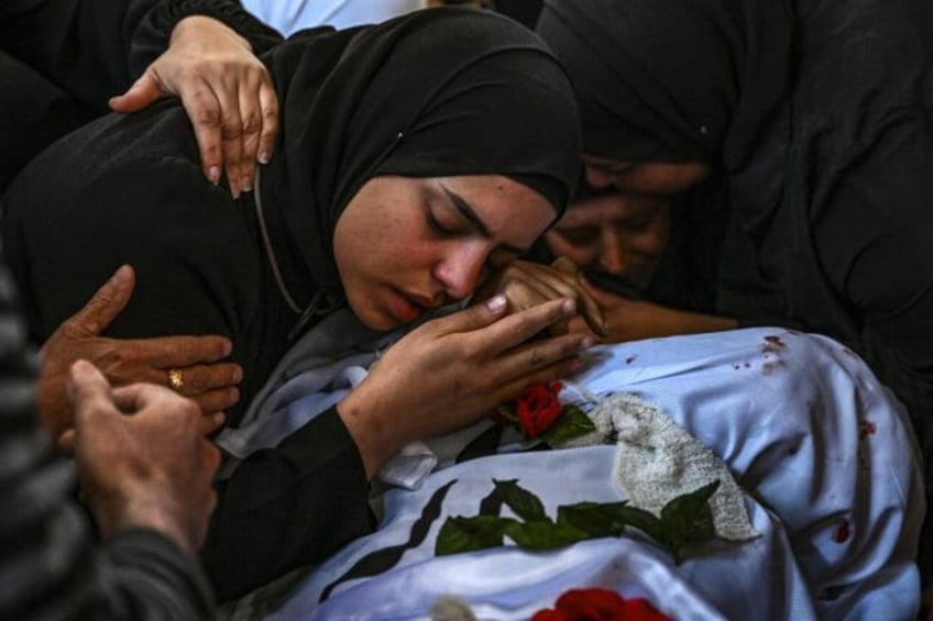 A funeral procession for 13 Palestinians killed in the Israeli army raid passed through ro