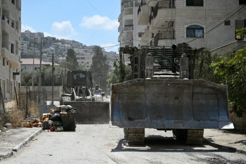 Israeli bulldozers rumble along a street in Jenin on August 31, 2024