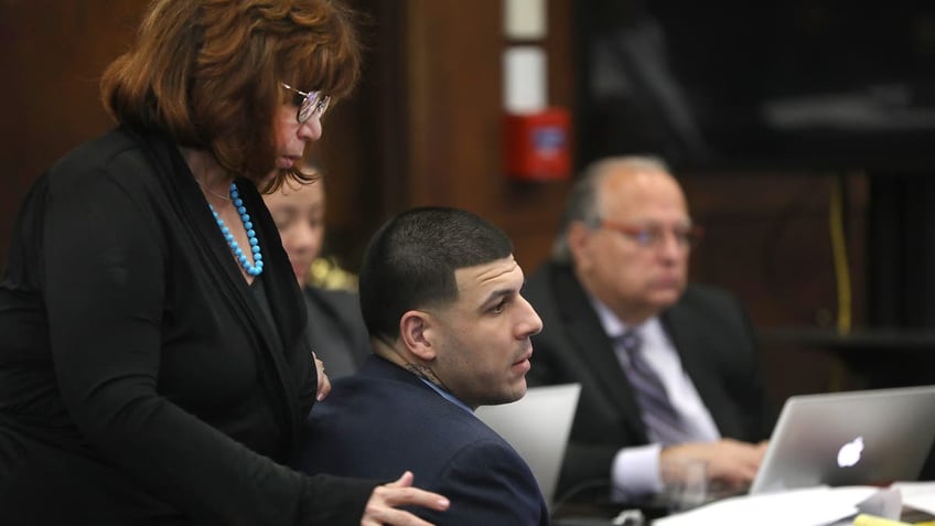  Linda Kenney Baden moves by former New England Patriots tight end Aaron Hernandez as his double murder trial