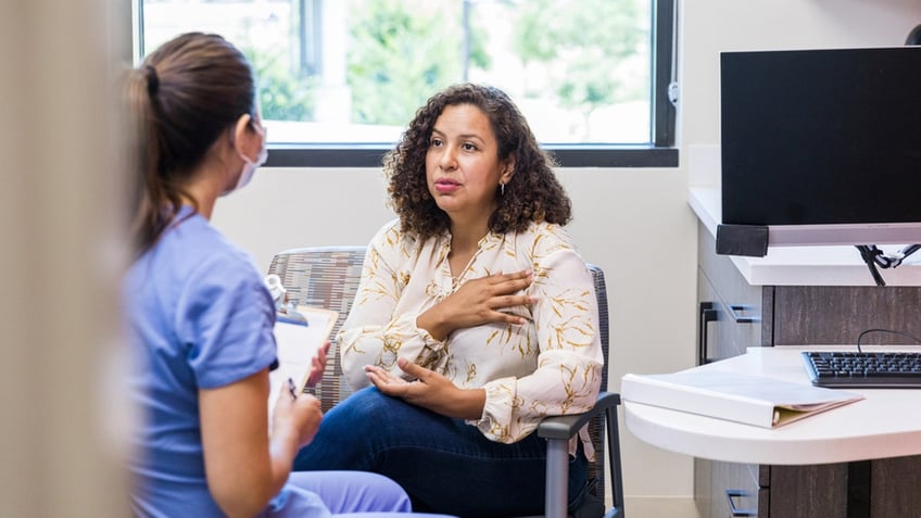 female patient talks with nurse about shoulder pain