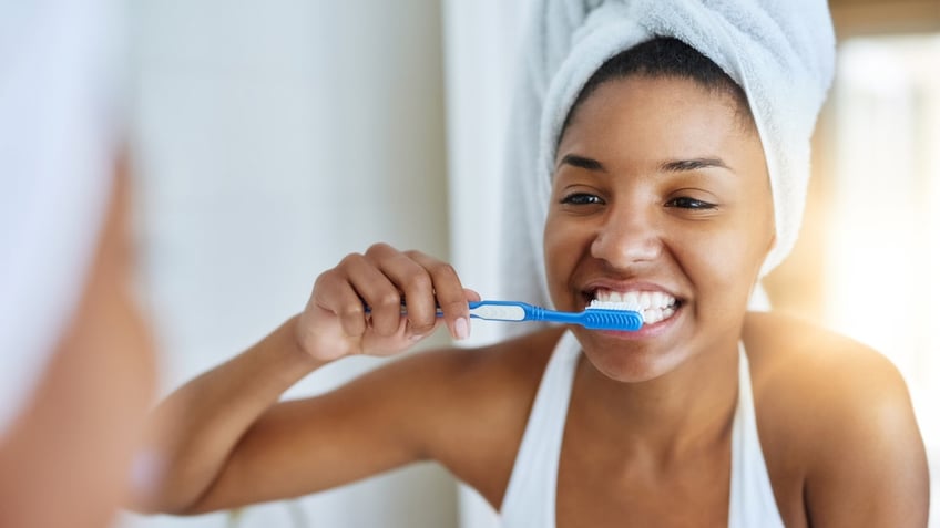 Woman brushing teeth