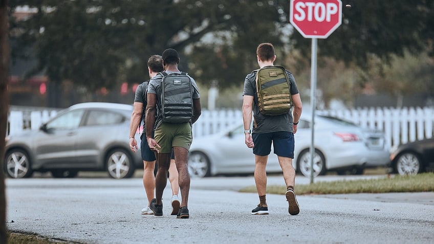 men rucking down the street