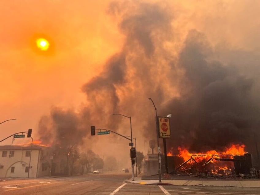 Flames from the wind-driven Eaton Fire engulf a house in Altadena, California, January 8,