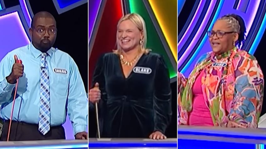 Tavaris in a blue shirt looking shocked, Beth in black and Tyra in hot pink on "Wheel of Fortune"