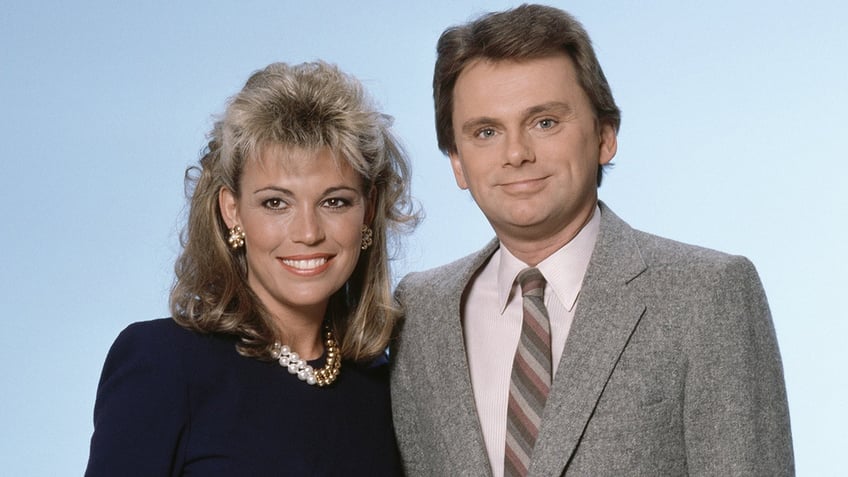 Pat Sajak and Vanna White posing for a promo pic