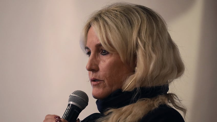 Erin Brockovich speaking into microphone